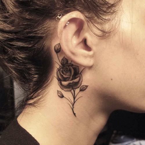 black and grey rose tattoo behind the ear