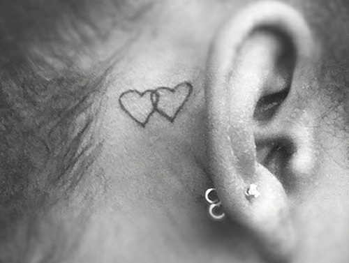 two interlocking hearts tattoo behind the ear