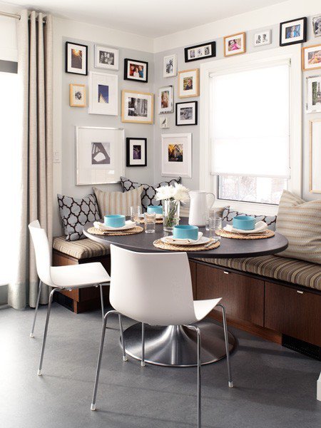 Gallery wall corner banquette with oval pedestal table