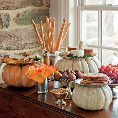 Cheese and cracker boards elevated on pumpkins