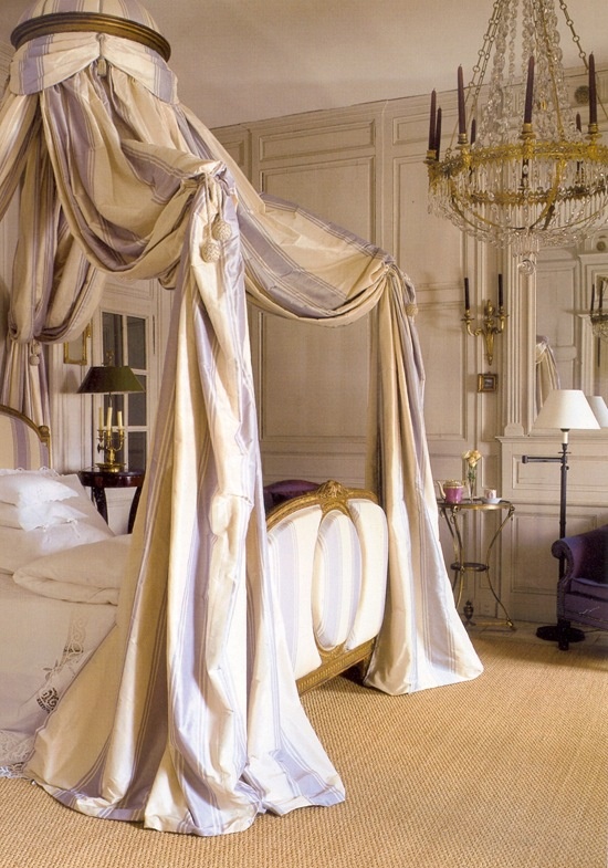 Gilded French canopy bed with cream and lavender striped drapery