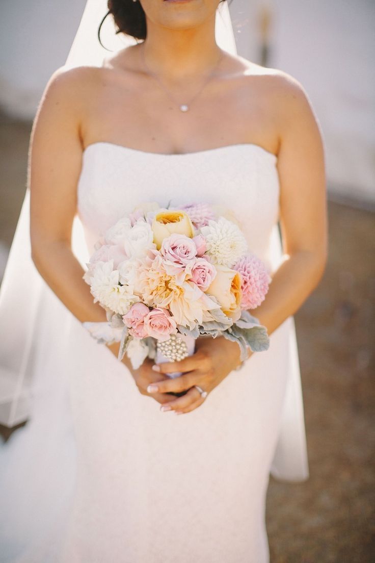 Bride holding a pink peony-forward bouquet