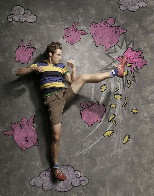 Man kicking chalk flying piggy banks that spill coins