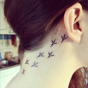 bird footprint trail tattoo behind ear down neck