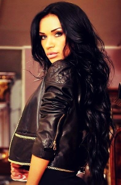 Dark hair draped over one shoulder