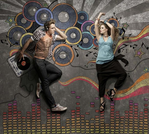 Overhead photo of a DJ and dancer interacting with chalk-drawn speakers and equalizer