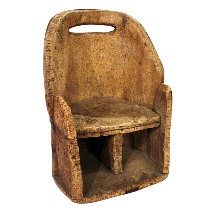 Monolithic cork or raw-material armchair with under-seat storage